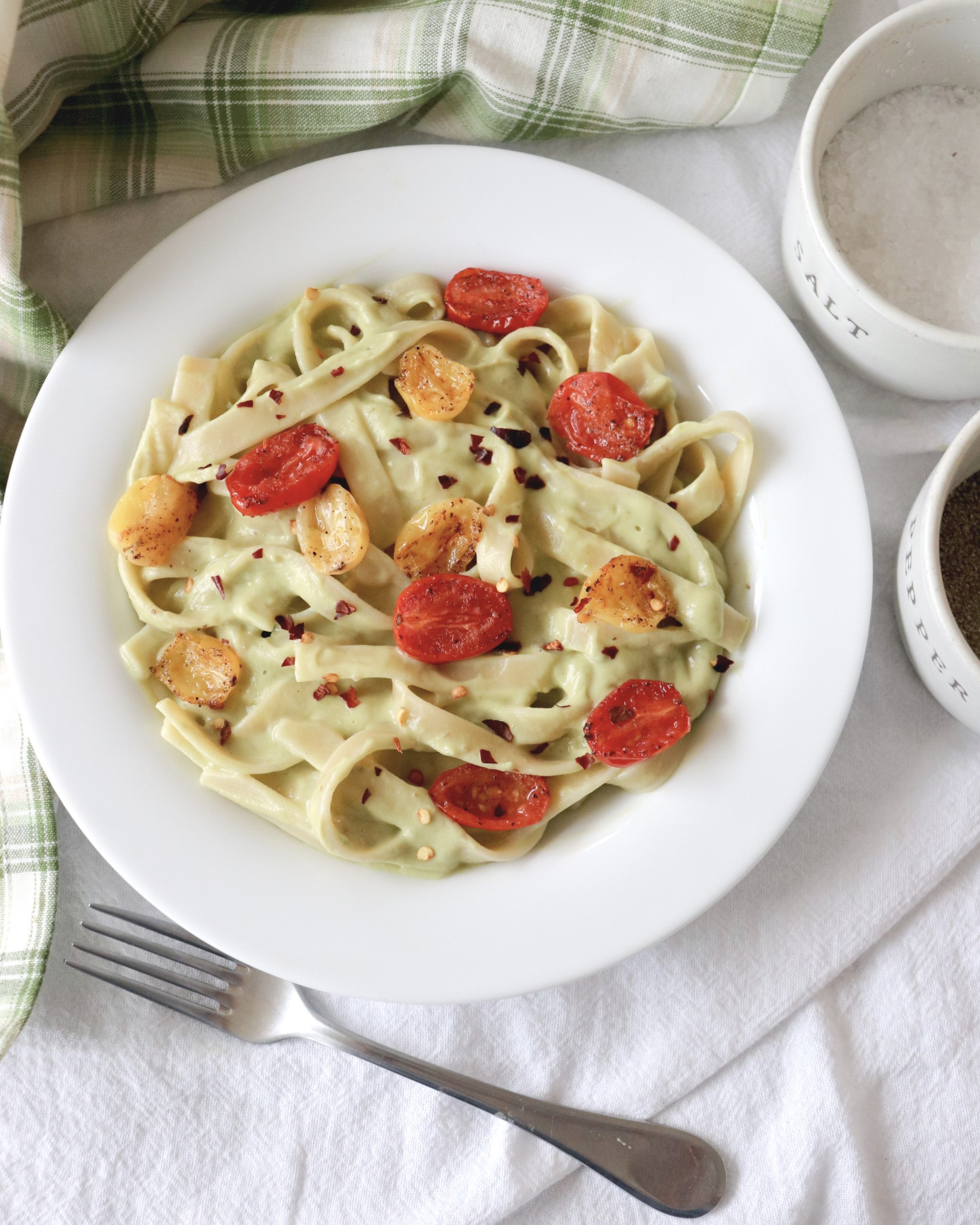 vegan pasta dish with avocado pesto and blistered tomatoes the modern day girlfriend